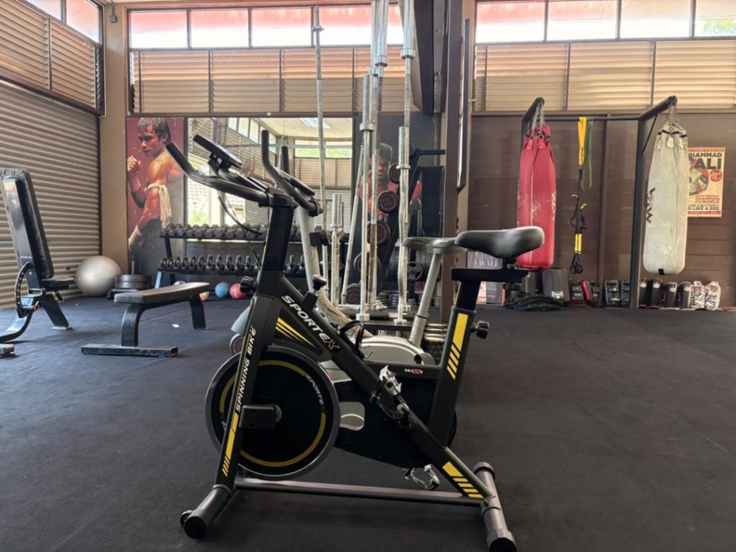 Spin bike, barbells and heavy bags in the Bambu Getaway training space