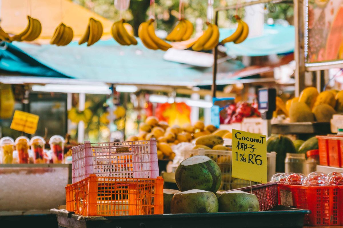 Fruit and produce stall with Malaysian ringgit prices at a Kuala Lumpur market